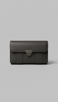 A premium leather tech organizer, centered against a clean Urban Gray backdrop. The product is perfectly framed with soft,...