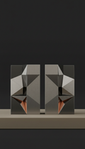Geometric bookend pair, Three-quarter angle is default—never flat lay—with product placed atop a low plinth against a...
